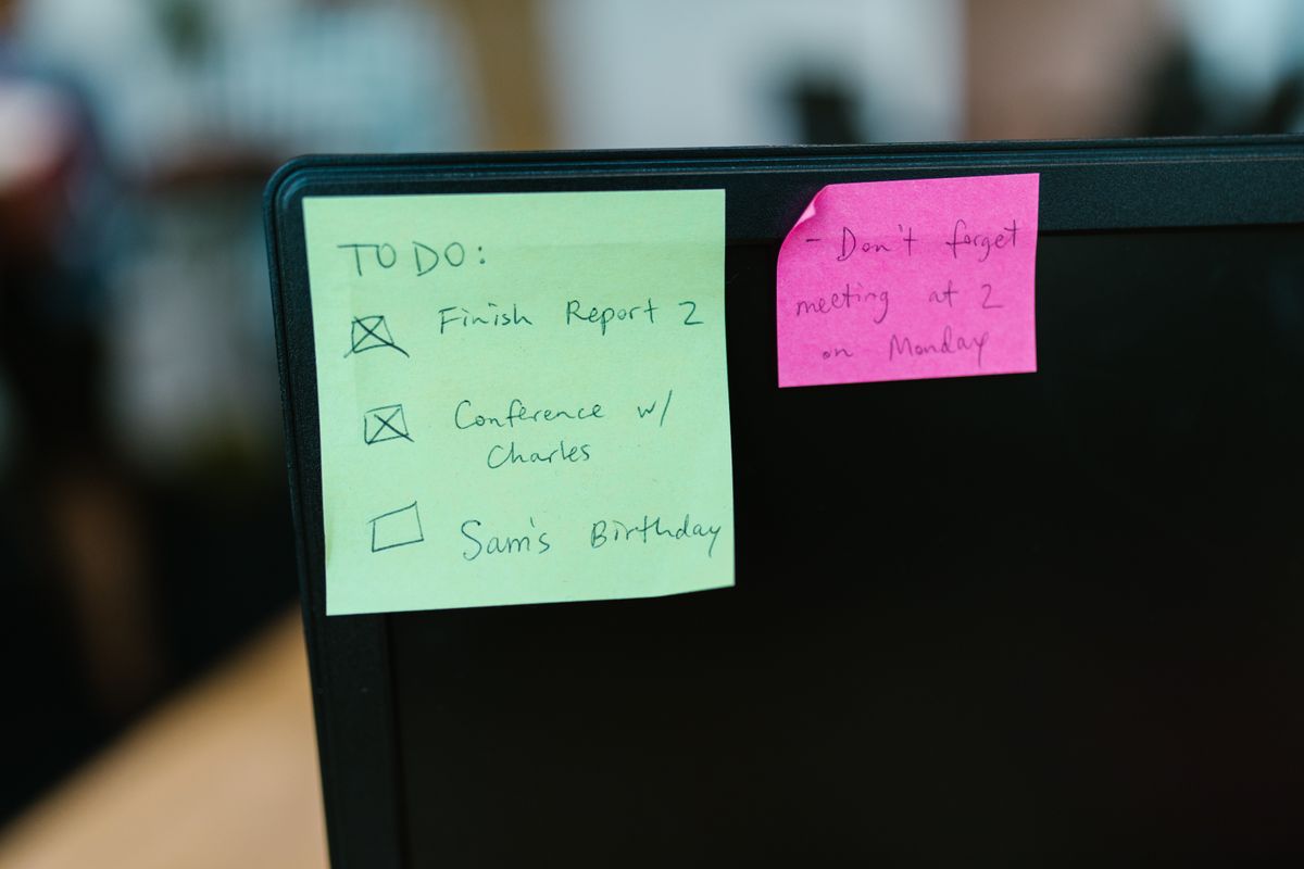 Sticky note reminders on a computer monitor