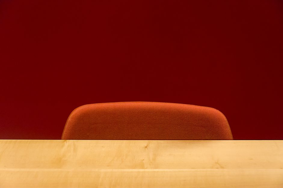 Empty office chair behind a bare desk