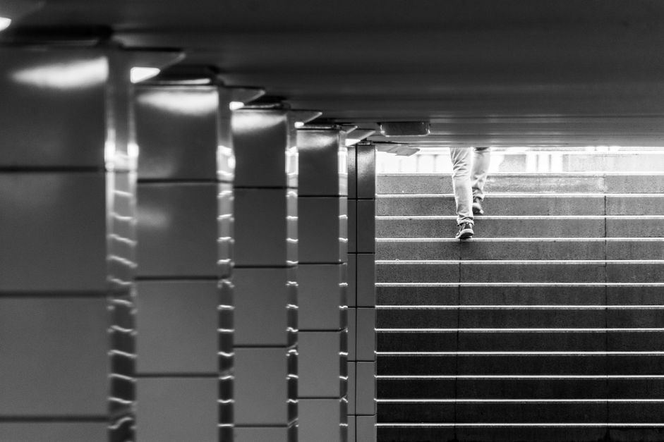 Person ascending a staircase, monochrome