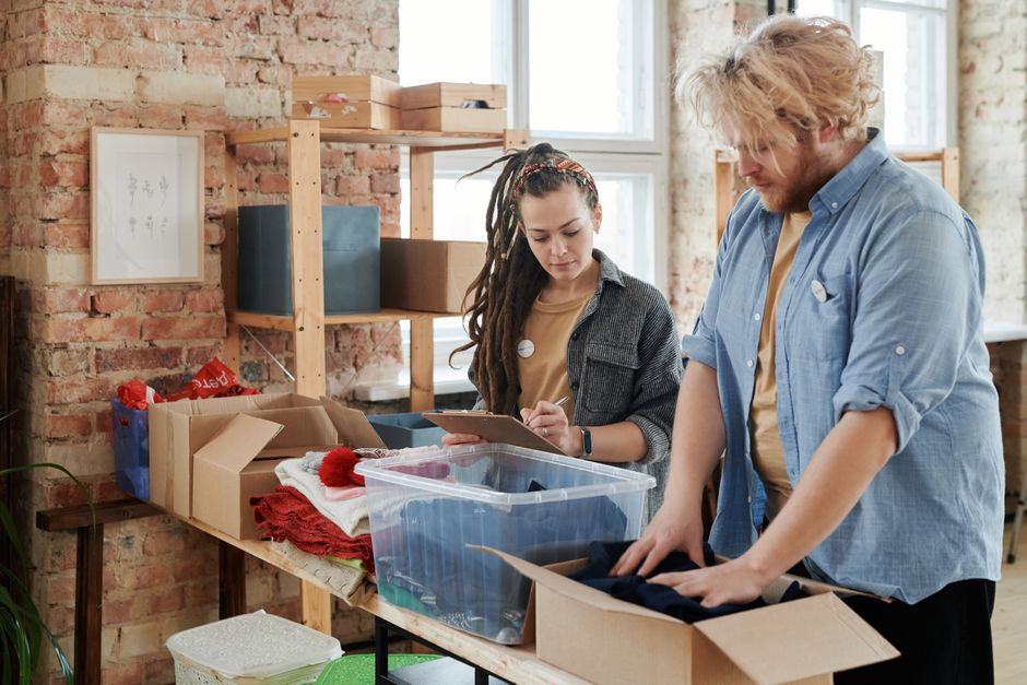 Two coworkers sorting and dividing items fairly between them