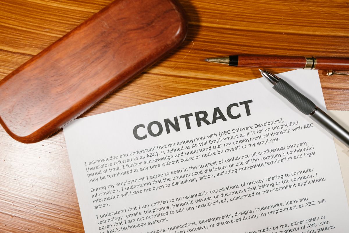 An unsigned contract and pen waiting on a desk