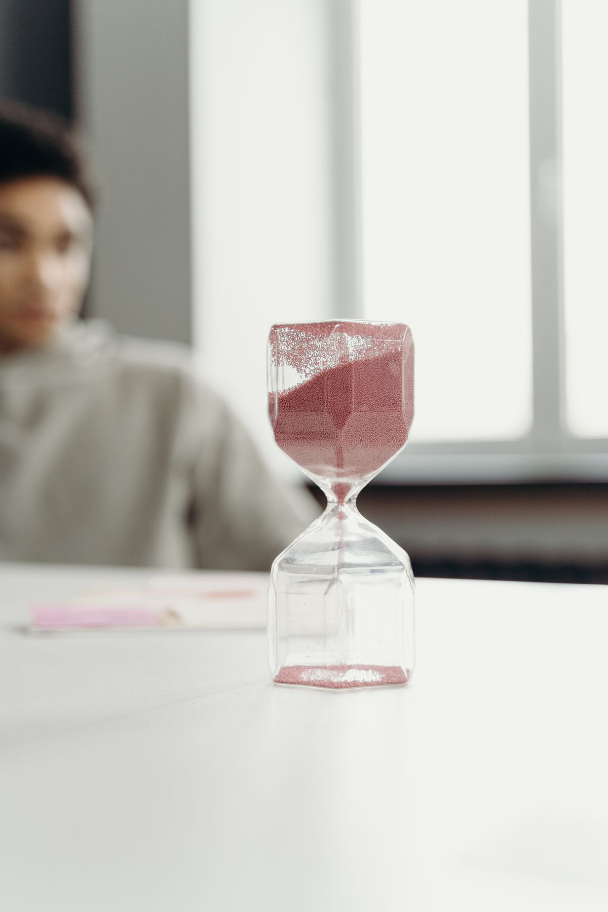 An hourglass on a table during a stalled meeting